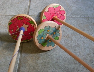 three Tiffany decorated drop (hand) spindles